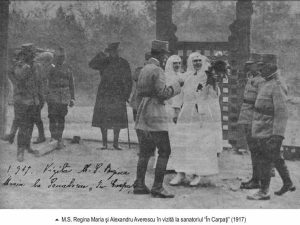 Queen Marie in white nurse uniform and Alexandru Averescu in military uniform alongside officers in 1917