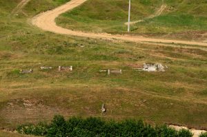 Ruins of the water catchment at Mărăști, located on a grassy slope near a dirt road