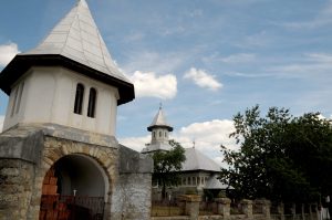 Bell tower with stone archway and Mary Magdalene Church in the background