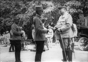 General Alexandru Averescu speaking outdoors with French General Henri Berthelot and other officers