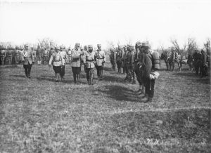 King Ferdinand and General Averescu reviewing troops on an open field