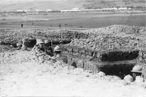Soldiers and officers sheltered in an earth-fortified trench