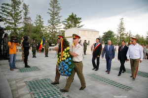Romanian soldiers carry a tricolor wreath during a commemorative ceremony at the Mărăști Mausoleum