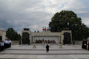 Maria Murgoci in traditional costume performing in front of the Mărășești Mausoleum during a ceremony
