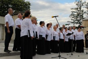 Pastorala Municipal Choir performing outdoors in front of microphones