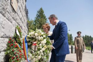 Princess Margareta and Prince Radu laying a white floral wreath at the Mărăști Mausoleum