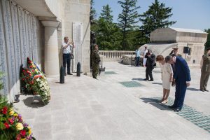 Princess Margareta and Prince Radu bowing before commemorative plaques with wreaths at the Mărăști Mausoleum