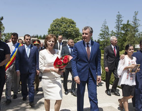 Princess Margareta and Prince Radu walking accompanied by an official delegation